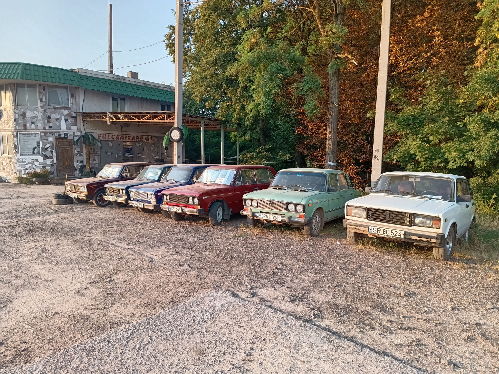 Old Lada cars outside a vulcanizare tyre workshop in Moldova