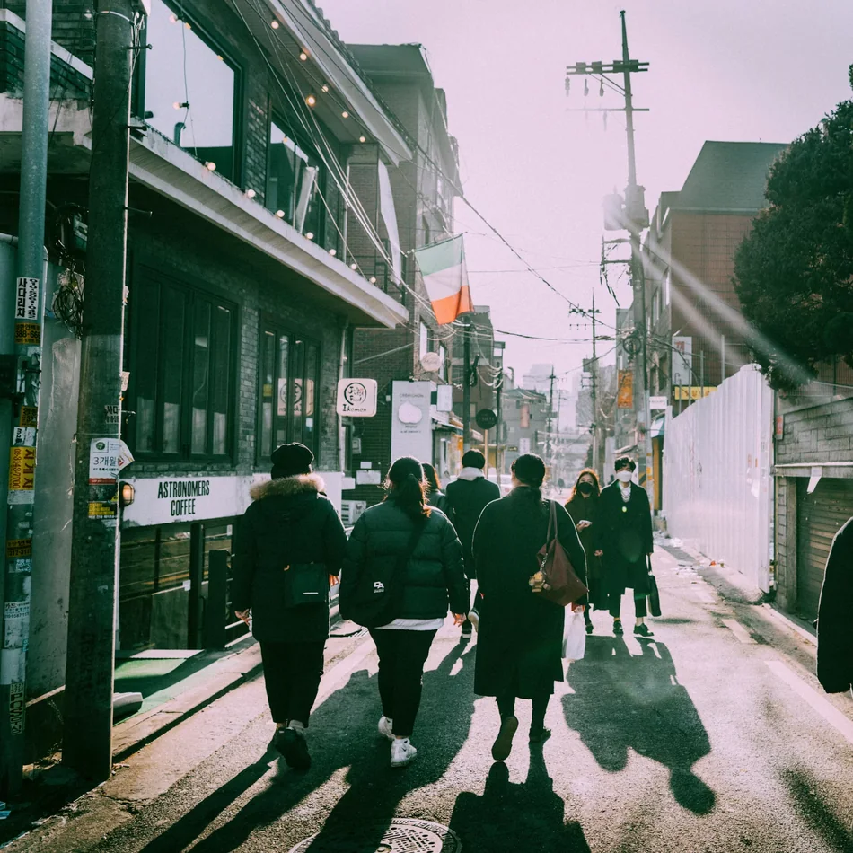Travellers walking together through a sunlit city street