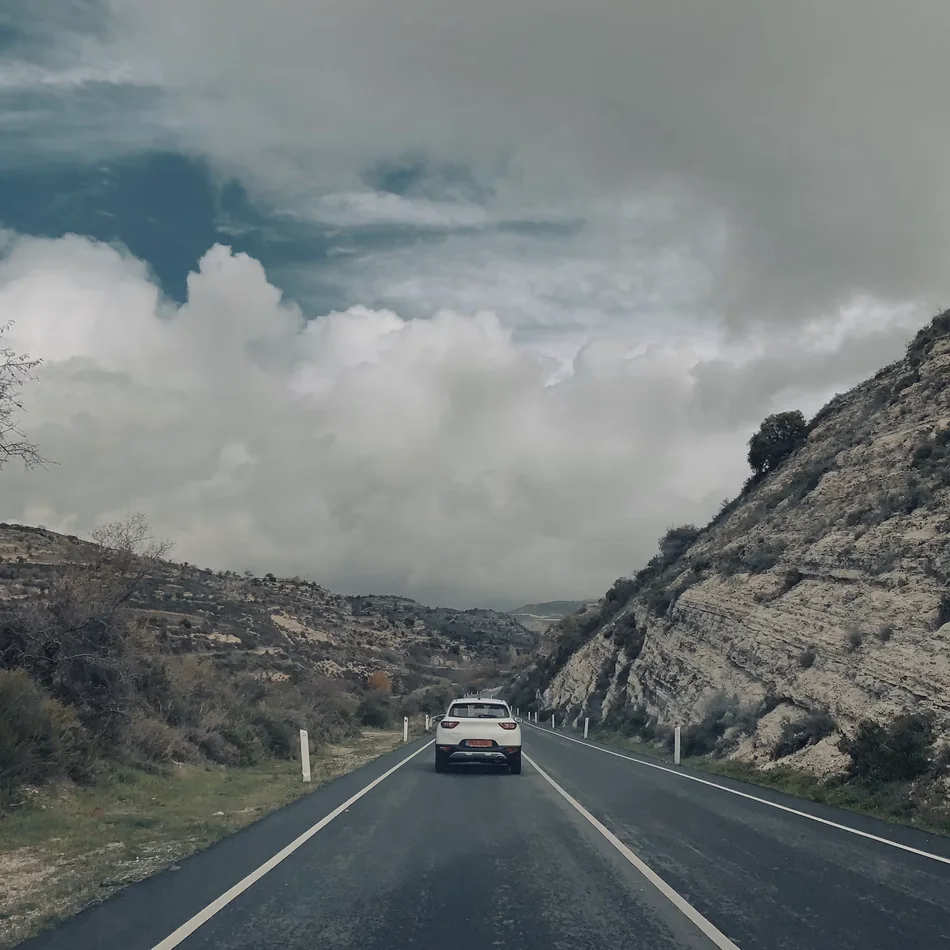 A car driving along a scenic winding road
