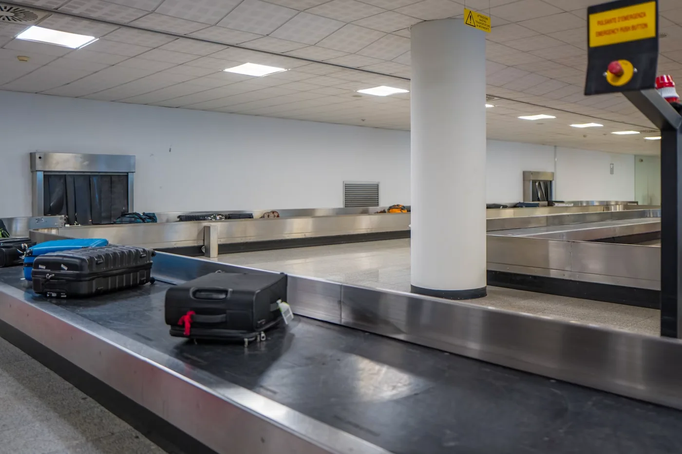 Suitcases moving through an airport baggage area
