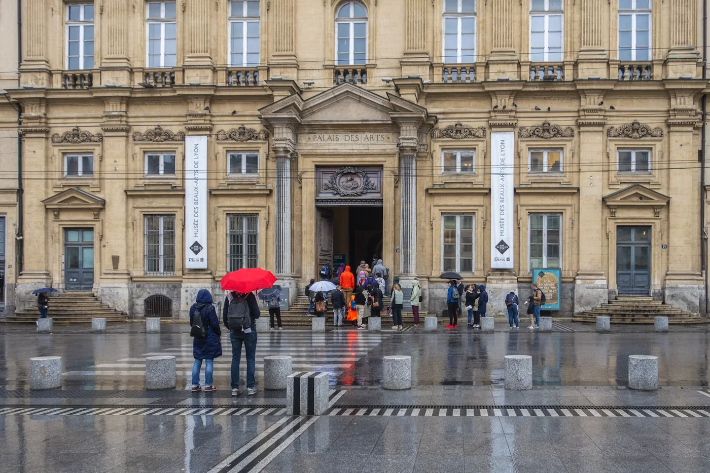 Visitors approaching the entrance of an art museum